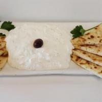 Tzatziki · Fabulous Greek yogurt, cucumber, and garlic. Served with four pita wedges.