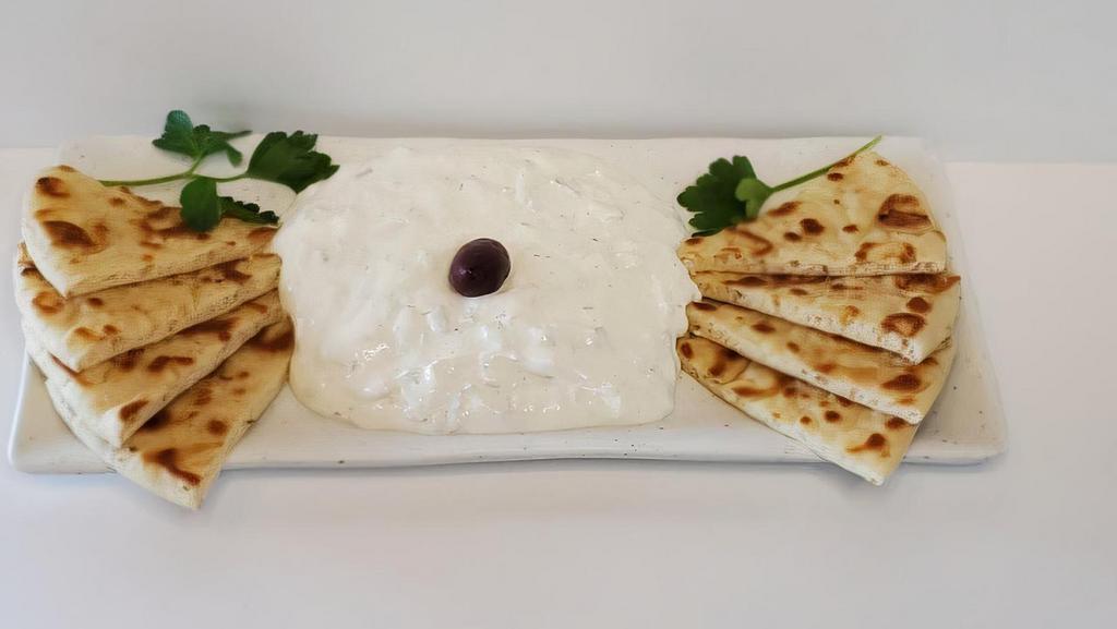 Tzatziki · Fabulous Greek yogurt, cucumber, and garlic. Served with four pita wedges.