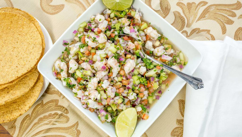 Shrimp Ceviche/Camaron · Raw shrimp cooked with fresh lime juice ,chopped onions, tomatoes, cilantro and cucumber.