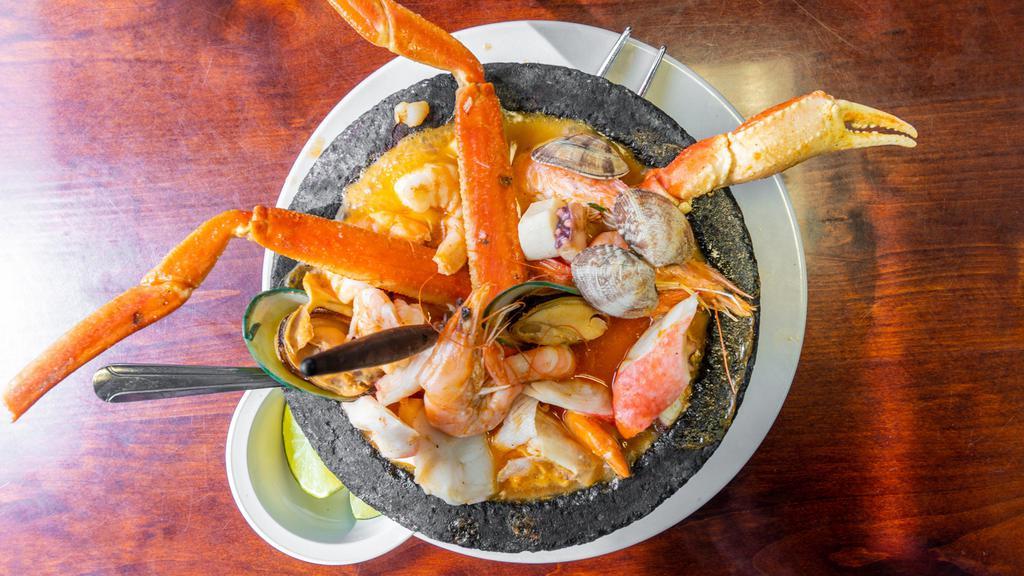 Molcajete San Blas · Shrimp, octopus, scallops, surimi, crab legs, mussels, and clams. Sautéed in a delicious hot sauce served in a sizzling molcajete plate.
