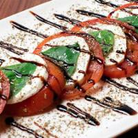 Caprese · Sliced tomato, fresh mozzarella, basil, balsamic reduction, salt, cracked pepper, oregano, a...