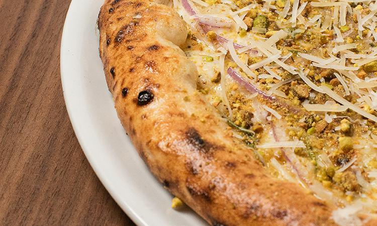 Francesca · Crushed pistachios, rosemary, red onion, shaved parmesan, fresh mozzarella, olive oil