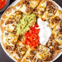 Nachos · Includes beans, cheese, lettuce, tomatoes, guacamole, and sour cream.