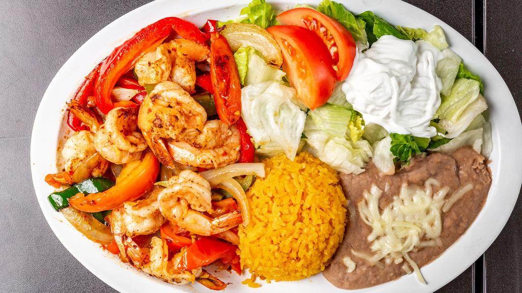 Fajitas Dinner · Grilled onion, green pepper, tomatoes. Choice of steak, chicken, or shrimp, served with lettuce, tomatoes, sour cream, guacamole, and tortillas. Served with a side of rice and beans.