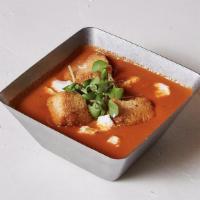Tomato Bisque · Tomato Bisque topped with house made croutons, goat cheese, and fresh basil
