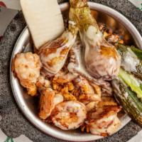 Molcajete · Grilled steak, chicken, shrimp, pork chop, chorizo, cactus, onions, and cheese with 2 stuffe...