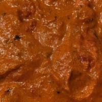 Chicken Tikka Masala · Pieces of chicken tikka cooked in a creamy sauce with fresh tomatoes, oriented spices.