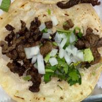 Taco (Corn Tortilla) · Authentic street taco on corn tortillas and topped with onion and cilantro.