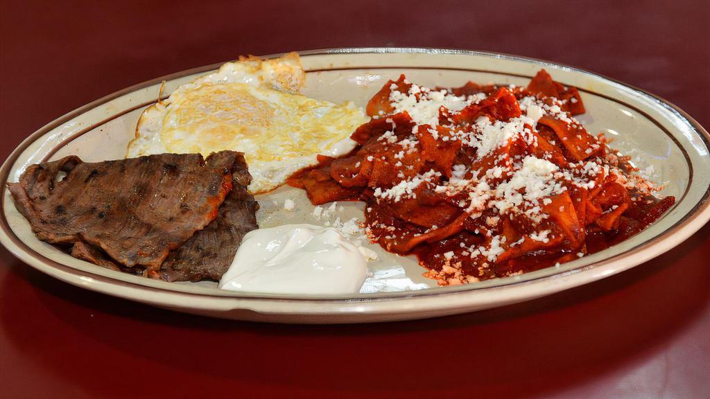 Chilaquiles · Corn tortillas cut into pieces and cooked with your choice of red or green sauce. Comes with an egg, ham or steak, & sour cream on the side.