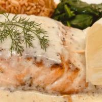 Garlic Herb Salmon · Wild Atlantic salmon grilled and served with sauteed spinach, lemon dill sauce, and Spanish ...