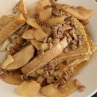 Apple Pecan Waffle · Golden brown Belgian waffle topped with fresh apple cinnamon glaze, pecans, and drizzed with...