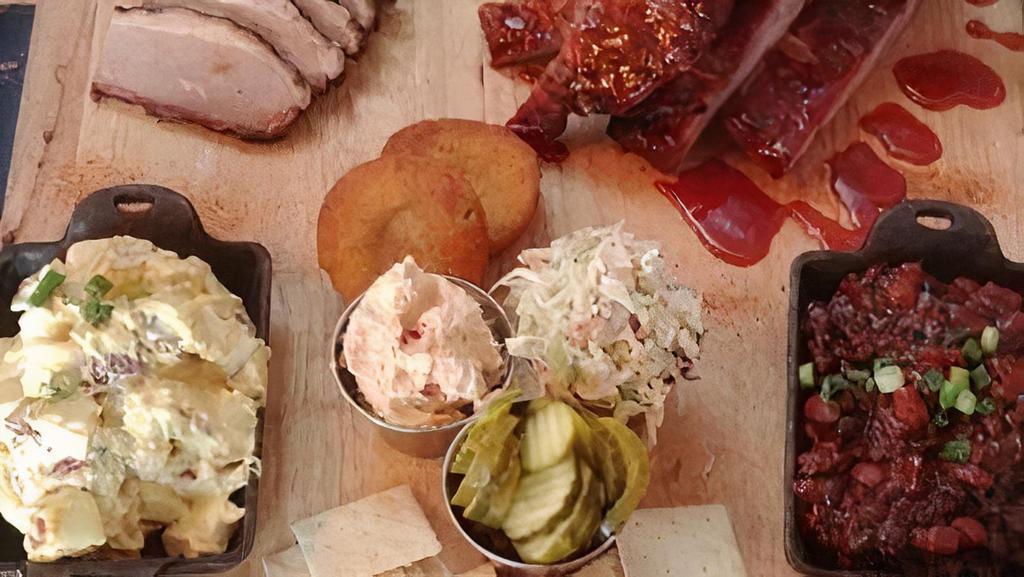 Try It All · ¾ Pound of Wings, ½ Pound of Pulled Pork, 2 sausage links, ¼  Rack of Ribs, 2 sides, Double Cornbread, Pimento Cheese, Coleslaw, Saltine Crackers, and Pickles