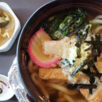 Nabe Udon · Udon noodles with fish cake, vegetables, egg, fried bean curd, and shrimp tempura.