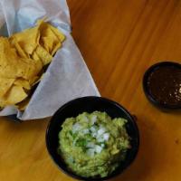 Guacamole · Mashed avocado mixed with cilantro, jalapeño, tomato, onion & lime juice. Tortilla chips.