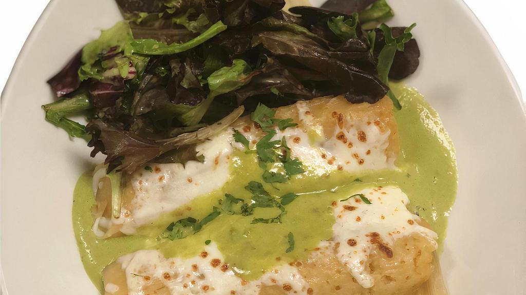 Tamales De Elote · 2 Corn tamales topped with poblano cream, melted cheese and cilantro.
