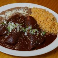 Enchiladas Con Mole · 3 Corn tortillas filled with choice of roasted chicken or beef picadillo.  Mole Coloradito, ...