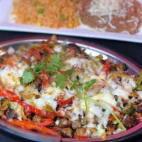 Alambre · Sauteed steak, chorizo & bacon with bell peppers, onions & melted cheese.  Mexican rice & pi...