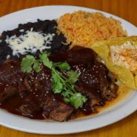 Brisket · Beef brisket in Mole Coloradito.  Black beans & Mexican Rice.  Grilled corn with chipotle ma...