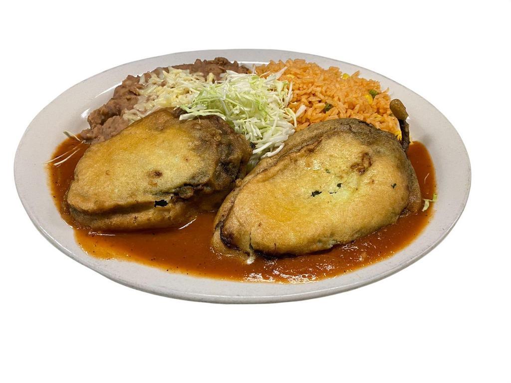 Chiles Rellenos · Egg battered stuffed poblano pepper filled with cheese or beef picadillo.  Roasted tomato sauce.  Mexican rice & pinto beans.