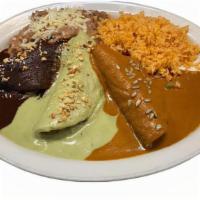Mole Trio Enchiladas · 3 Homemade corn tortillas filled with chicken breast.  Topped with 3 different moles.  Mexic...