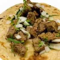 Asada Steak Taco · Grilled garlicky lime-marinated sirloin steak. 
Topped with onions and cilantro.