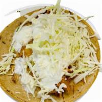 Tinga De Pollo Taco · Shredded chicken with caramelized onions in a roasted tomato chipotle sauce.  Topped with so...