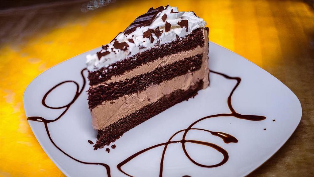 Chocolate Mousse Cake · Three layers of moist chocolate cake with creamy chocolate mousse filling and topped with chocolate whipped cream.