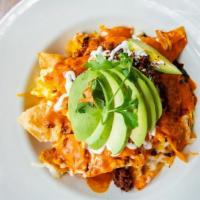 Chilaquiles · Tortilla chips, mixed with scrambled eggs, red sauce, and black beans. Topped with chorizo, ...