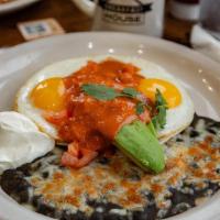 Huevos Rancheros · Two sunny-side-up eggs served on a corn tortilla with black beans, pepper jack cheese, avoca...