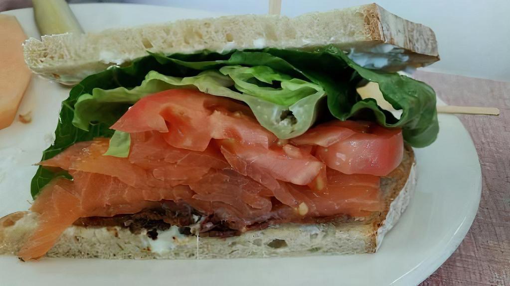Smoked Salmon Sandwich · Cold smoked salmon, cream cheese, capers, tomato, on an everything bagel.