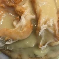 Open Face Chicken Sandwich · Slice of bread with mashed potatoes, sliced chicken strip and gravy on top.