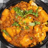 Aloo Gobi  · 16 oz. Punjabi classic made with potatoes (aloo) and cauliflower (gobi), cooked along with t...