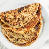 Aloo Paratha · 2pcs. Flatbread stuffed with mashed potato and spices cooked on tawa with butter or oil.