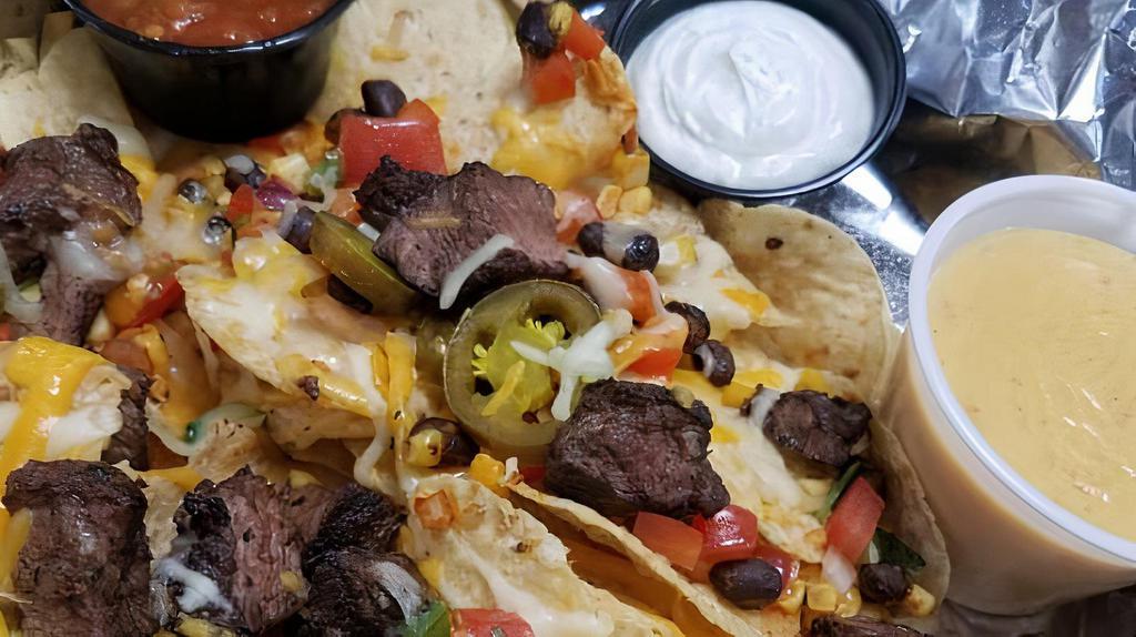 Maria'S Nachos & Queso · Corn tortilla chips baked with shredded cheese, black bean-corn salsa, jalapeno and pico de gallo. Your choice of steak, chicken or Beyond taco. Served with sides of queso, salsa and sour cream