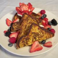 French Toast & Berries · Two  pieces  of French  toast  served  with  whipped  cream  and   seasonal berries.