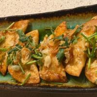 Crispy Spicy Chicken Wontons · (6)-Fried homemade dumplings, spicy sesame dressing, green onions and cilantro