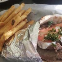 Gyro Sandwich · Pita bread with rotisserie beef and lamb meat, onions, tomatoes, and taziki sauce.