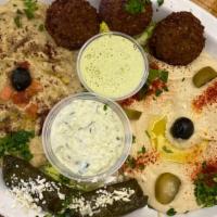 Sampler · Hummus, babaghanouj, falafel, and grape leaves served with pita, tahini and tazike sauce