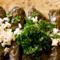 Vegetarian Grape Leaves (8 Rolls) · Grape leaves stuffed and rolled with seasoned rice topped with feta cheese. Served with our ...