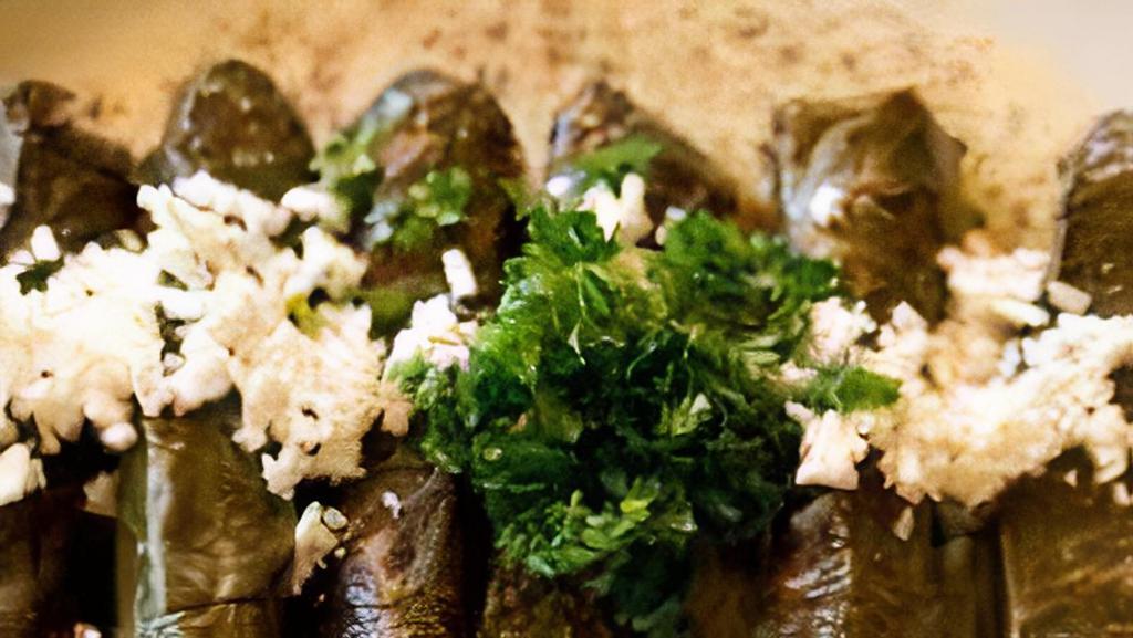 Vegetarian Grape Leaves (8 Rolls) · Grape leaves stuffed and rolled with seasoned rice topped with feta cheese. Served with our homemade tzatziki sauce.
