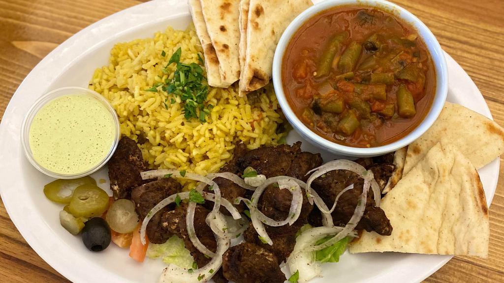 Lamb Kabob (2 Skewers) · Grilled seasoned lamb with garlic and black pepper served with homemade tahini sauce and fresh pita bread. Served with Greek salad, rice, and green beans.