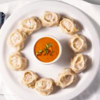 Chicken Momo · Hand-made dumpling filled with meat, cabbage, onion, scallion, cilantro, garlic, and ginger.