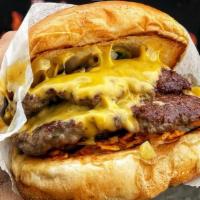Oklahoma Smashed Burger · Two patties, grilled onions, peppers, American, Doritos cheese, The Spot sauce.