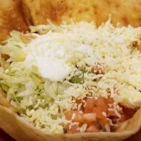 Taco Salad · Our classic salad of lettuce in a flour tortilla shell with tomatoes, shredded cheese, sour ...