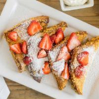 Crunchy French Toast · Sliced challah bread, dipped in cornflakes and grilled to perfection, sprinkled with strawbe...