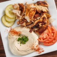 Chicken Shawarma · Shaving that was marinated and slow roasted served with tomatoes onion and garlic sauce.
