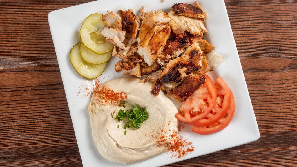 Chicken Shawarma · Shaving that was marinated and slow roasted served with tomatoes onion and garlic sauce.