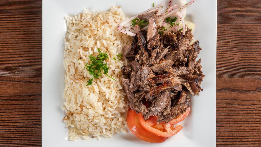 Meat Shawarma · Shaving that was marinated and slow-roasted served with tomatoes, onions and tahini sauce.