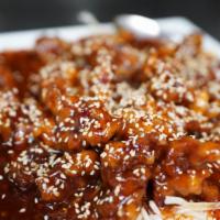 Sesame Beef · Thin sliced beef, lightly breaded, in sweet & spicy orange sesame sauce.  Served with white ...