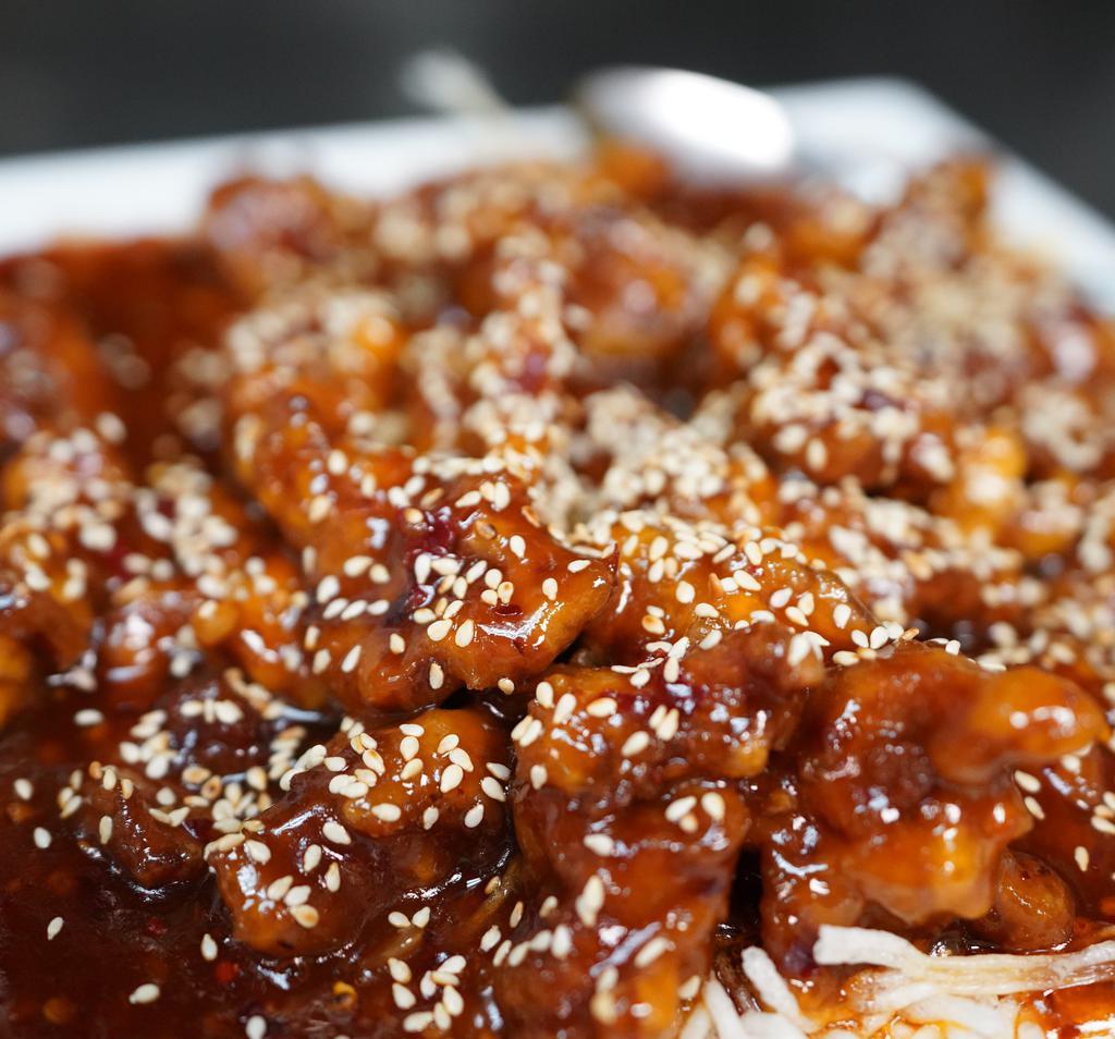 Sesame Beef · Thin sliced beef, lightly breaded, in sweet & spicy orange sesame sauce.  Served with white rice.